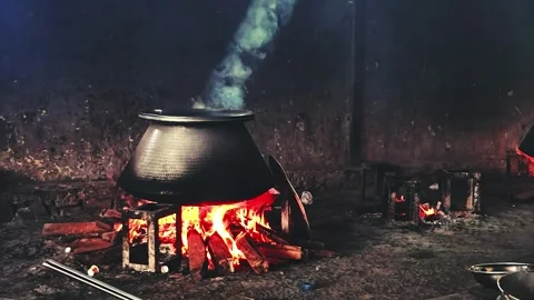 Traditional Indian cooking scene featuring a large metal pot boiling over a.. Stock Footage 341355826