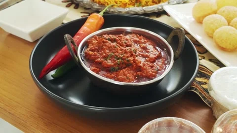 Traditional Indian curry served in a rustic bowl with fresh red, green chilli. Stock-Footage 302350434