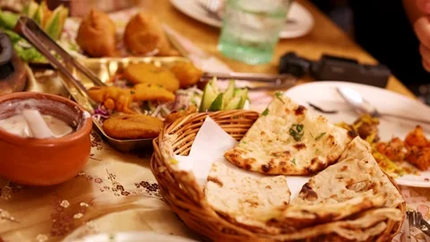 Traditional Indian Platter with Naan Bread Samosas and Pakoras Video stock 338375205