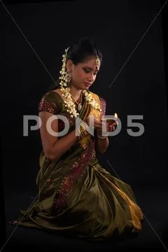 Traditional indian woman with oil lamp during the celebration of deepawali or Stock Photos