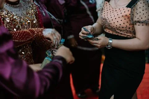 Traditional Indonesian wedding ceremony involves exchanging money between f.. Stock Photos