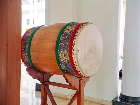 Traditional Islamic drum bedug and a hanging gong stand in a mosque courtya.. Stock Photos