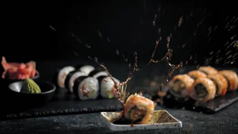 Close-up 4K slow-motion video of salmon sushi making. The sauce is