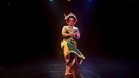 Traditional Javanese Dancer Balancing on One Leg in Classical Pose Stock Photos