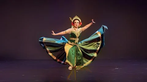 Traditional Javanese Dancer Displaying Flowing Costume in Elegant Stage Per.. Stock Photos