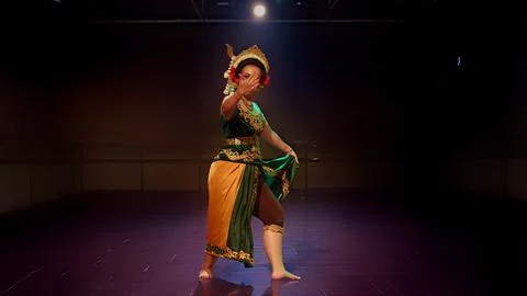 Traditional Javanese Dancer Pointing Forward in Dramatic Stage Performance Stock Photos