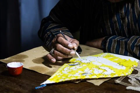 Traditional Javanese shadow puppet colouring process using small brush and .. 스톡 사진