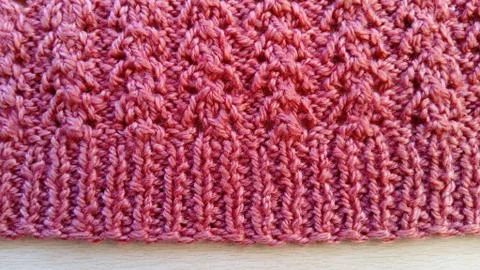 Traditional knitted pattern with crochets of thread forming beautiful, even h Stock Photos