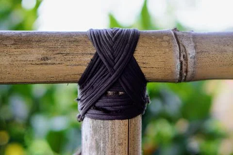 Traditional knotting technique using black rope to connect bamboo framework Stock Photos