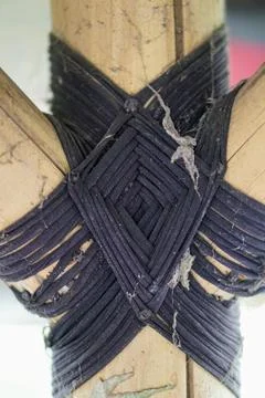 Traditional knotting technique using black rope to connect bamboo framework Stock Photos
