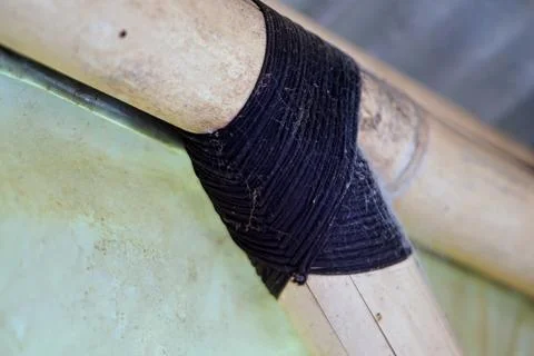 Traditional knotting technique using black rope to connect bamboo framework Stock Photos