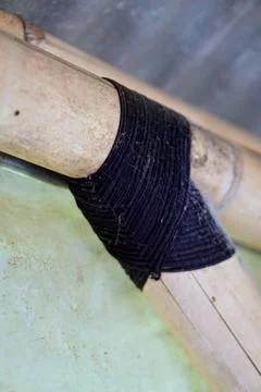 Traditional knotting technique using black rope to connect bamboo framework Stock Photos
