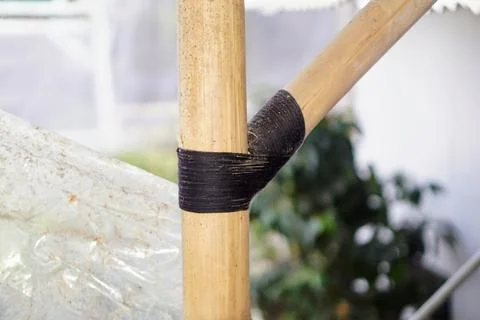 Traditional knotting technique using black rope to connect bamboo framework Stock Photos