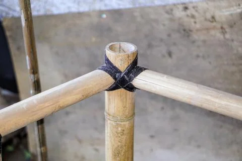 Traditional knotting technique using black rope to connect bamboo framework Stock Photos