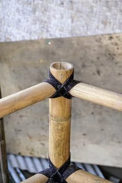 Traditional knotting technique using black rope to connect bamboo framework Stock Photos