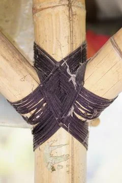 Traditional knotting technique using black rope to connect bamboo framework Stock Photos