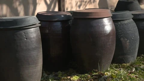 Traditional Korean Earthenware Jars on a Wall Fence Stock Footage 334511179