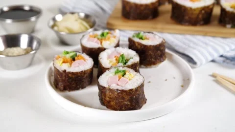 Traditional Korean food kimbap, with ham, vegetables and lettuce Stock Footage 282531253