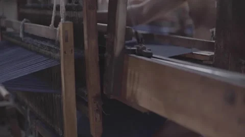 The traditional loom is being worked from yarn to cloth Stock Footage 248799223