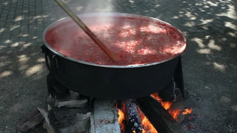 Traditional making tomato paste in boiler with wood fire in the village Stock-Footage 115350543
