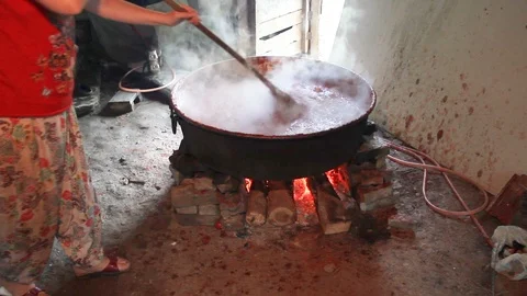 Traditional making tomato paste in boiler with wood fire in the village Stock Footage 115351627