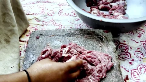 Traditional Meat Preparation by Beating Meat on Stone Stock-Footage 339530877