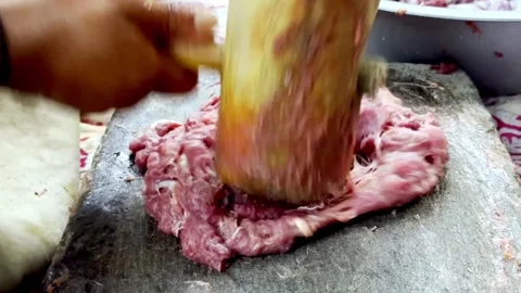 Traditional Meat Preparation by Beating Meat on Stone Видео 339530880