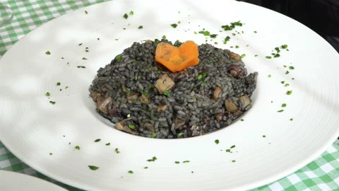 Traditional mediterranean black risotto - rice with seafood on a traditional Med Stock Footage 106629400