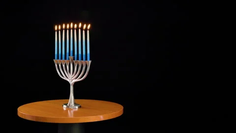 Traditional Menorah initially rotating with all candles lit. Stock Footage 323127746