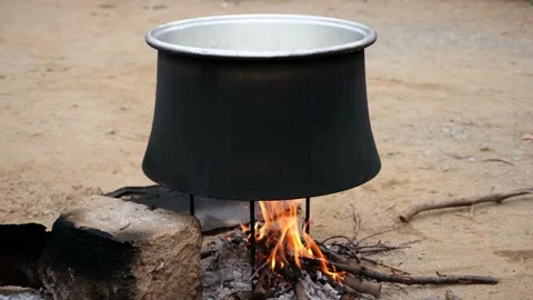 The traditional method is cooking in a cauldron over the fire. Video stock 168023319