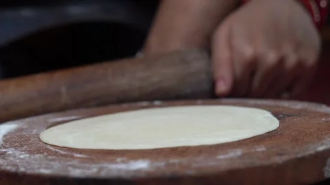 Traditional Method of Rolling Out Wheat Flour Dough for Roti or Chapati. Stock Footage 339870567
