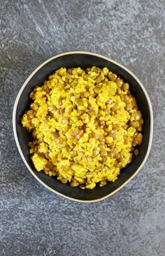 Traditional Middle Eastern dish Mujadara: lentils and rice on a dark backgrou Stock Photos