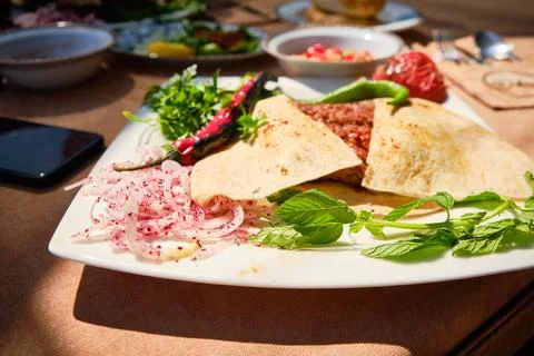 Traditional Middle Eastern Meat Flatbread with Fresh Herbs and Vegetables Stock Photos