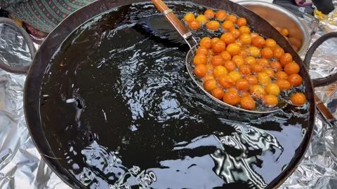 Traditional Middle Eastern sweets street cooking. Fresh luqaimat frying in hot Video stock 345739224
