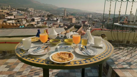 Traditional moroccan breakfast served on a rooftop terrace overlooking the Video stock 334116153