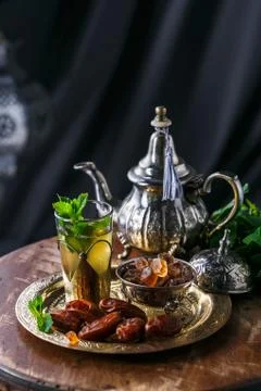 Traditional moroccan mint tea with copper teapot, dates and sugar Stock Photos
