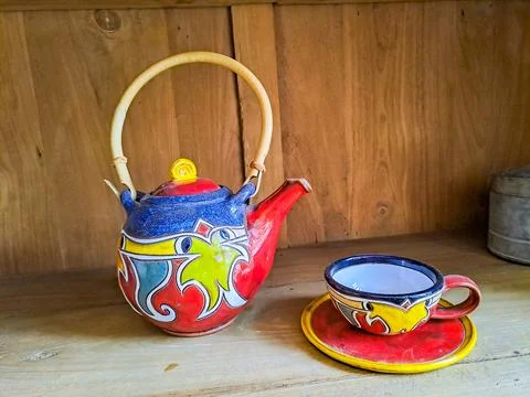Traditional multi-colored teapot with cup on saucer, beautiful souvenir in Czech Stock Photos