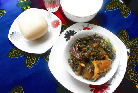 A traditional Nigerian meal of Pounded yam and thick vegetable soup Stock Photos