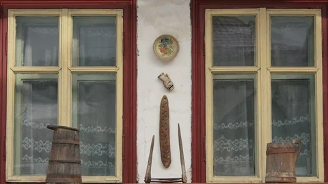 Traditional objects hung between two windows Stock Footage 88051948
