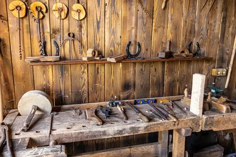 Traditional Old Blacksmith Workshop Bench with Tools and Horseshoe Stock Photos