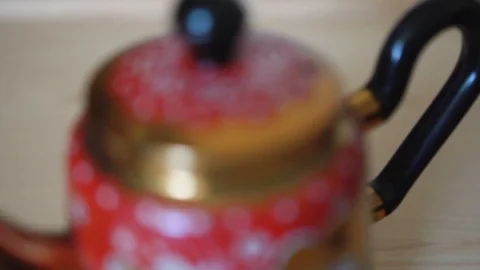 Traditional old fashioned teapot in kitchen, slowmotion shot Stock Footage 89176181