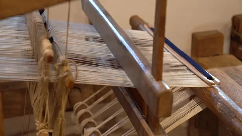 Traditional old weaving loom with white yarn and a blue shuttle Stock Footage 339754784