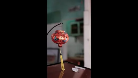 Traditional orange silk lantern with butterfly patterns hanging indoors Stock Footage 337420972