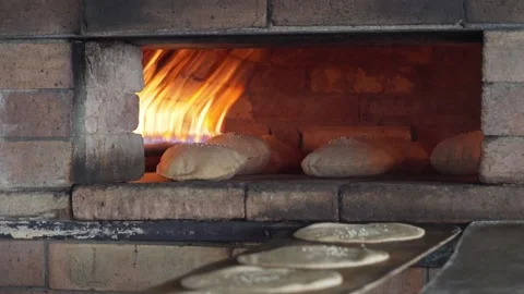 Traditional oriental bread baking in a brick oven Stock Footage 151323488