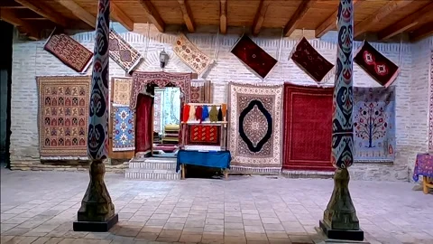 Traditional oriental carpet workshop with handmade rugs in Bukhara at night Stock-Footage 335928668