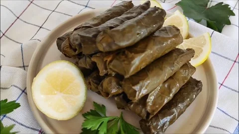Traditional oriental Turkish dolma made of grape leaves stuffed with rice Stock Footage 252179076