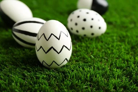 Traditional painted Easter eggs on green lawn, space for text 写真素材