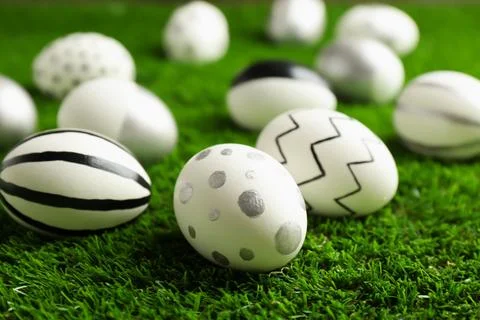 Traditional painted Easter eggs on green lawn, closeup 写真素材