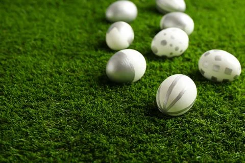 Traditional painted Easter eggs on green lawn, space for text 写真素材