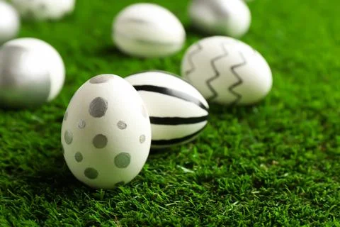 Traditional painted Easter eggs on green lawn, closeup 写真素材